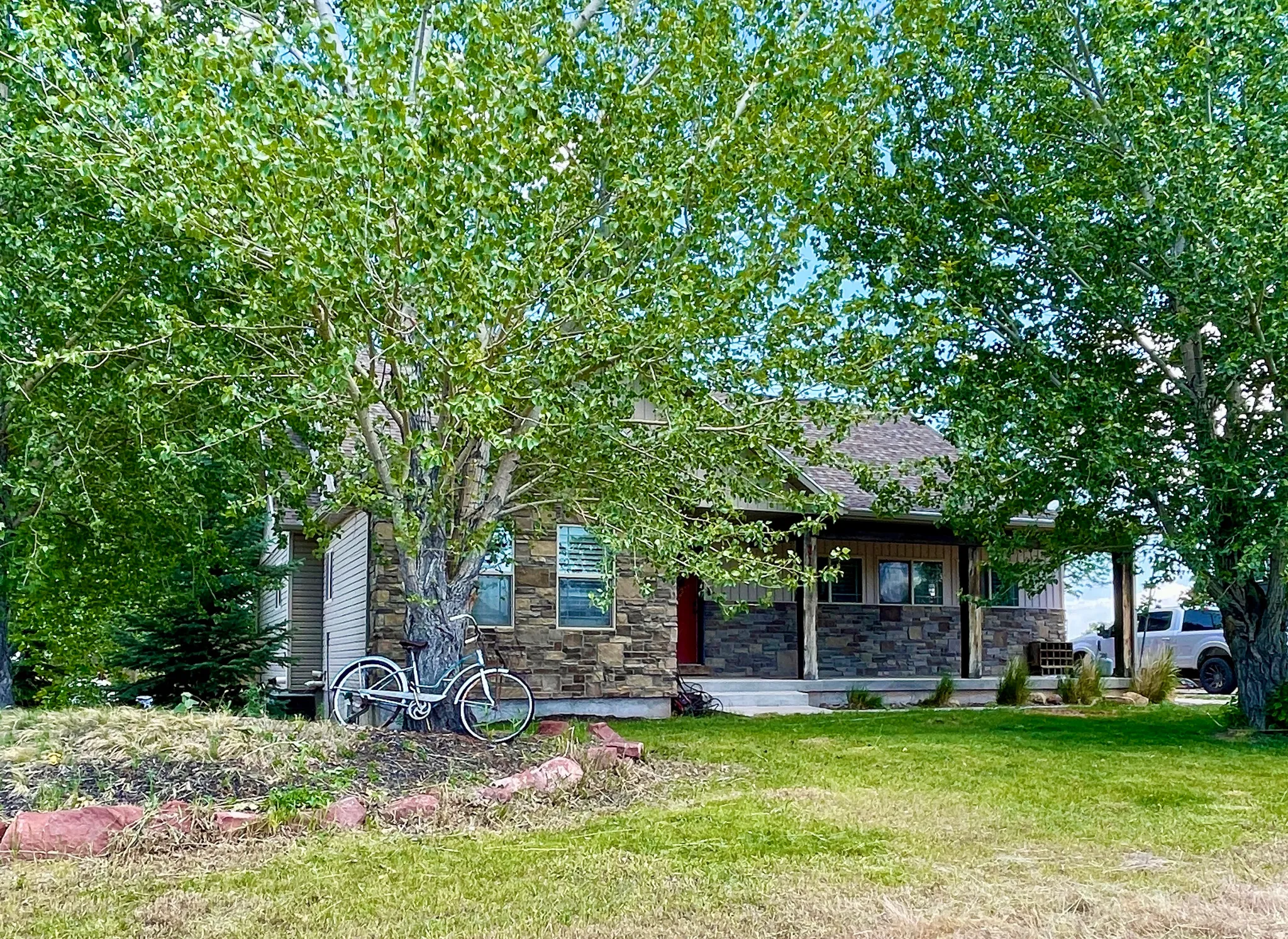 Front exterior featuring stacked stone and horizontal siding