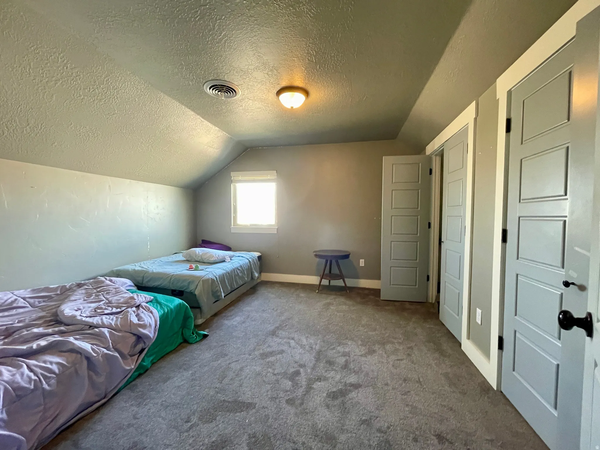 Carpeted bedroom featuring baseboards
