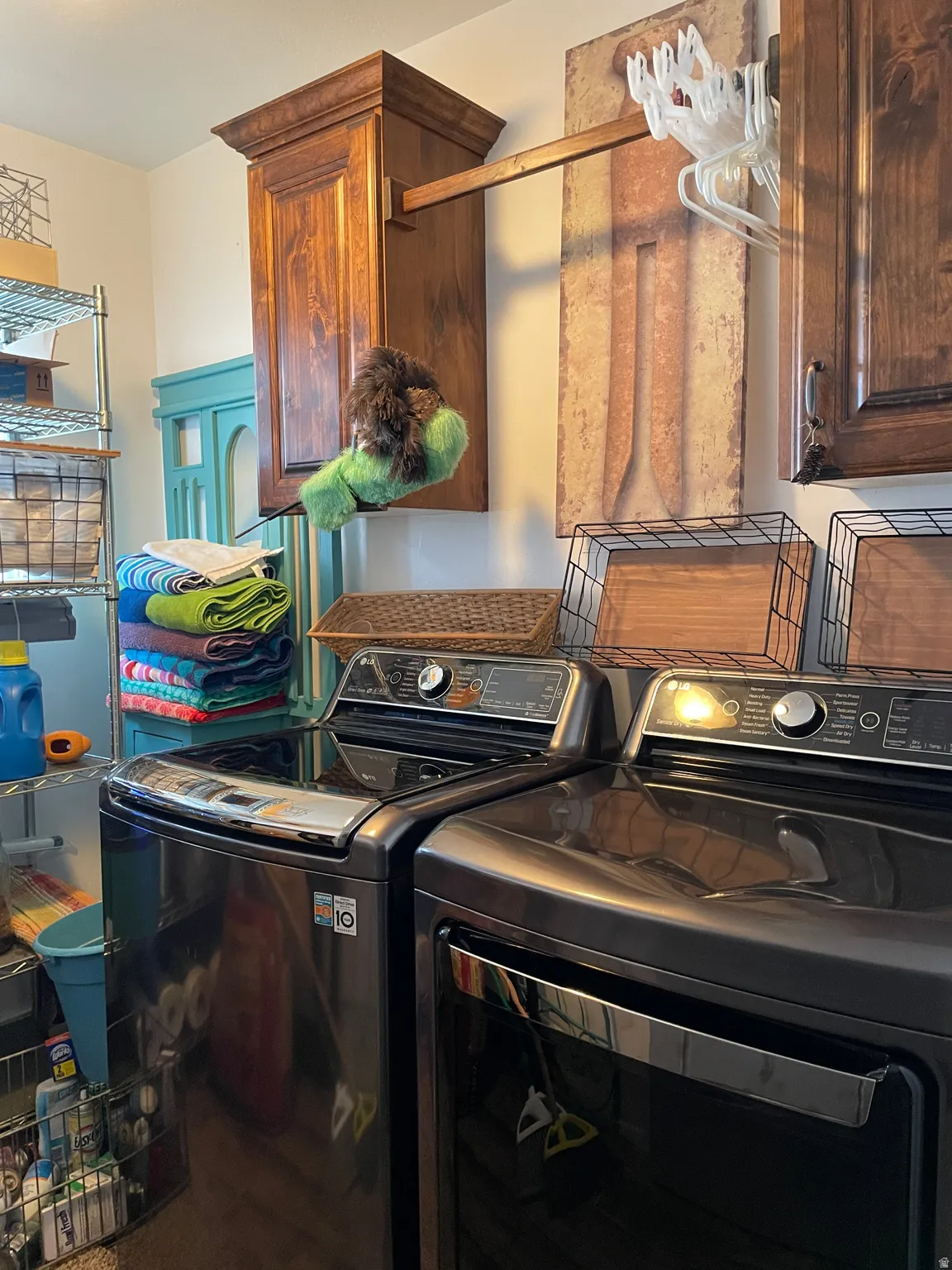 Laundry room with separate washer and dryer and cabinet space