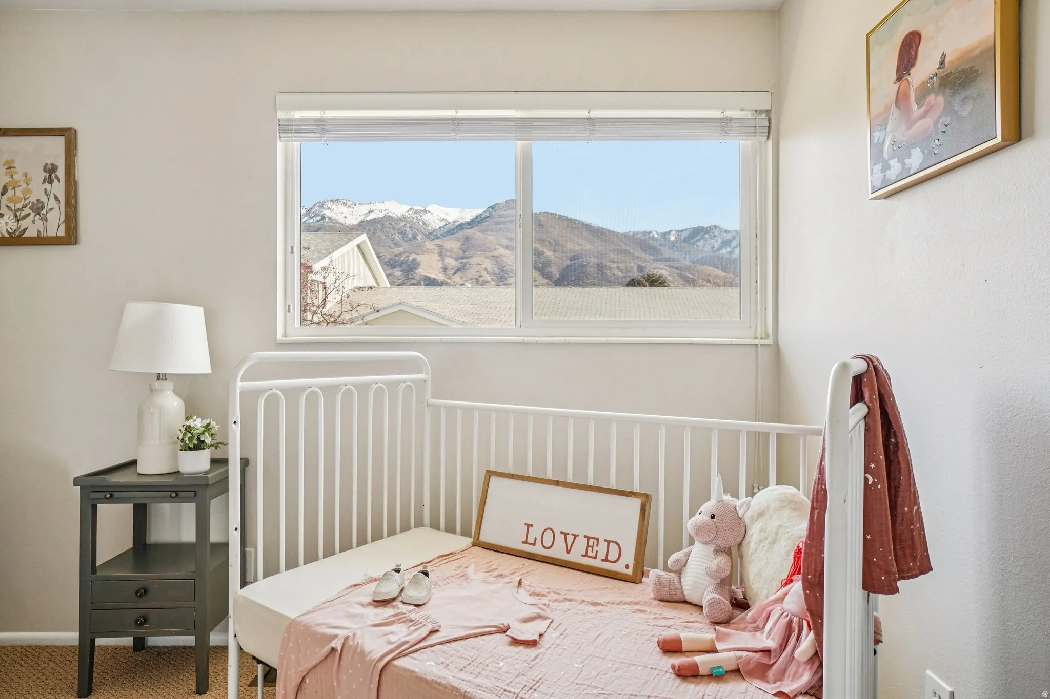 Bedroom with multiple windows, carpet flooring, and a mountain view