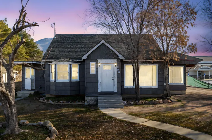 Bungalow-style house with roof with shingles and entry steps