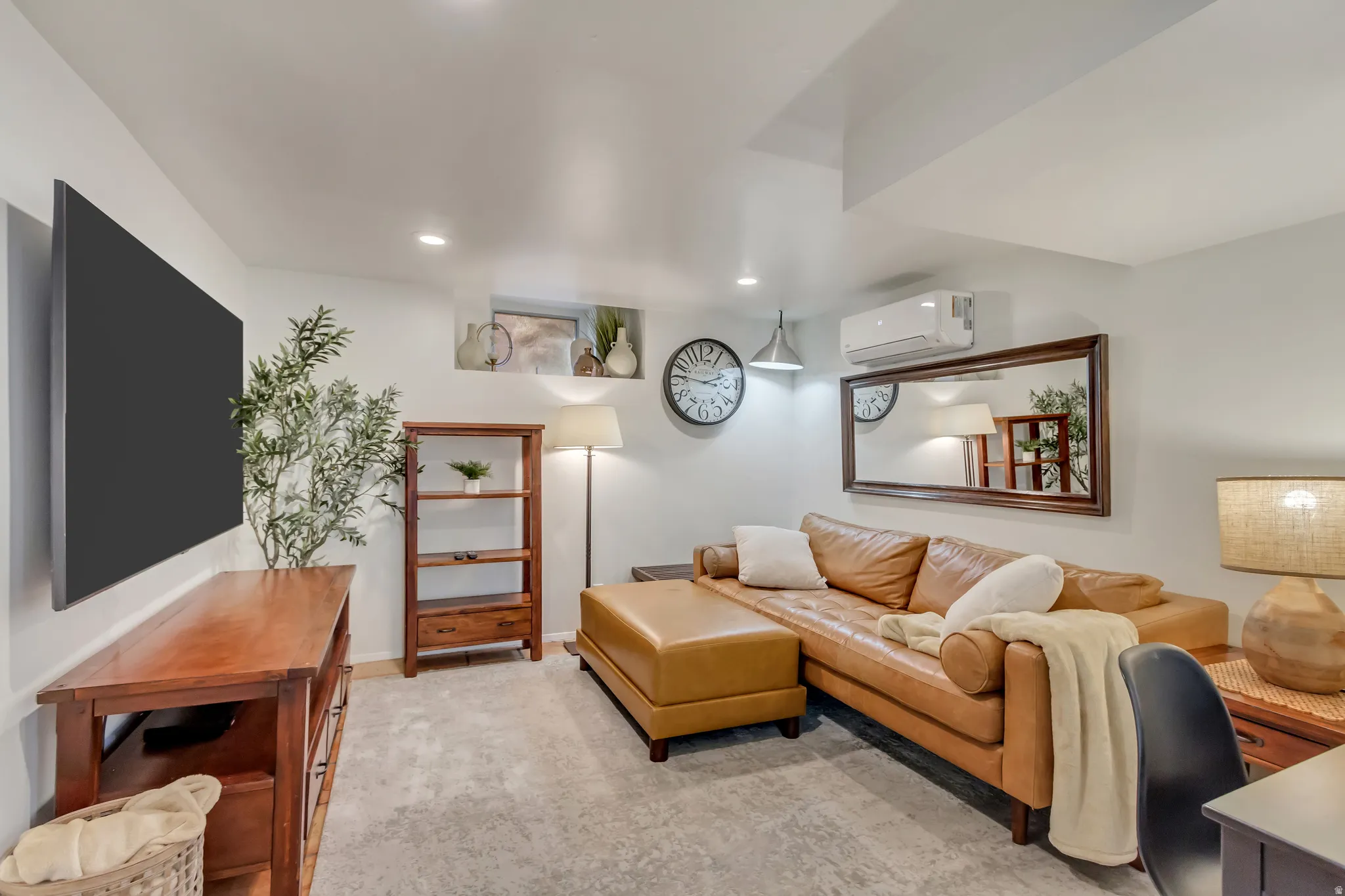Apt. #5 Family Room featuring tiled floors, mini-split heating/cooling, and recessed lighting.