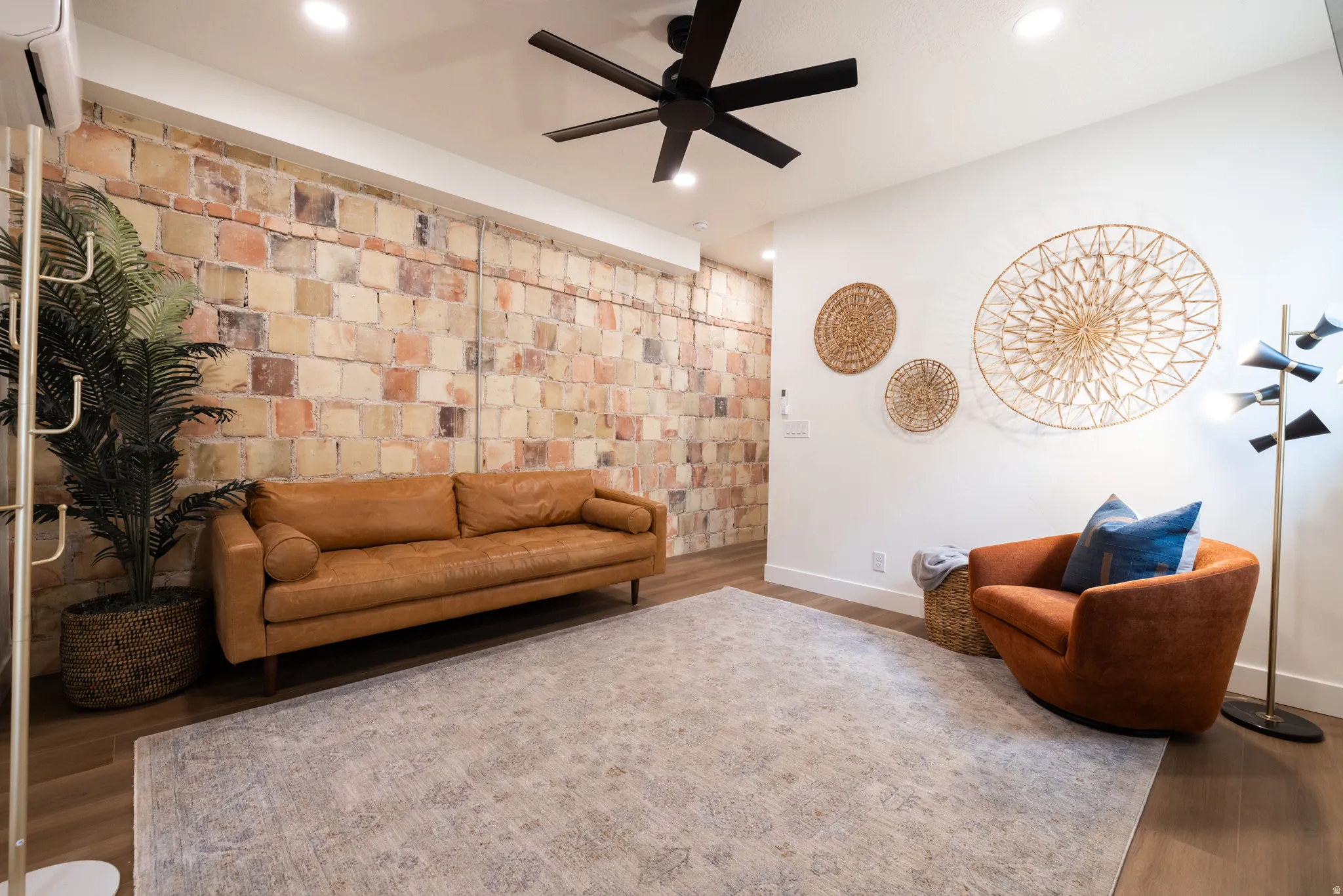 Apt. #2 Family room featuring original rock accent wall, recessed lighting, and wood finished floors