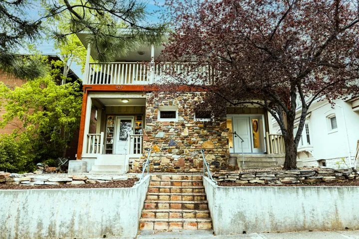 View of front of property featuring private balconies and porch's