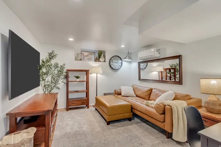 Apt. #5 Family Room featuring tiled floors, mini-split heating/cooling, and recessed lighting.