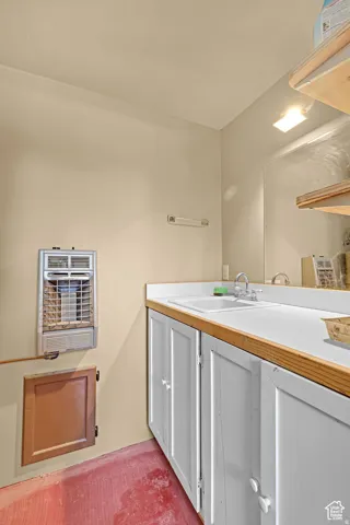 Bathroom featuring vanity and heating unit
