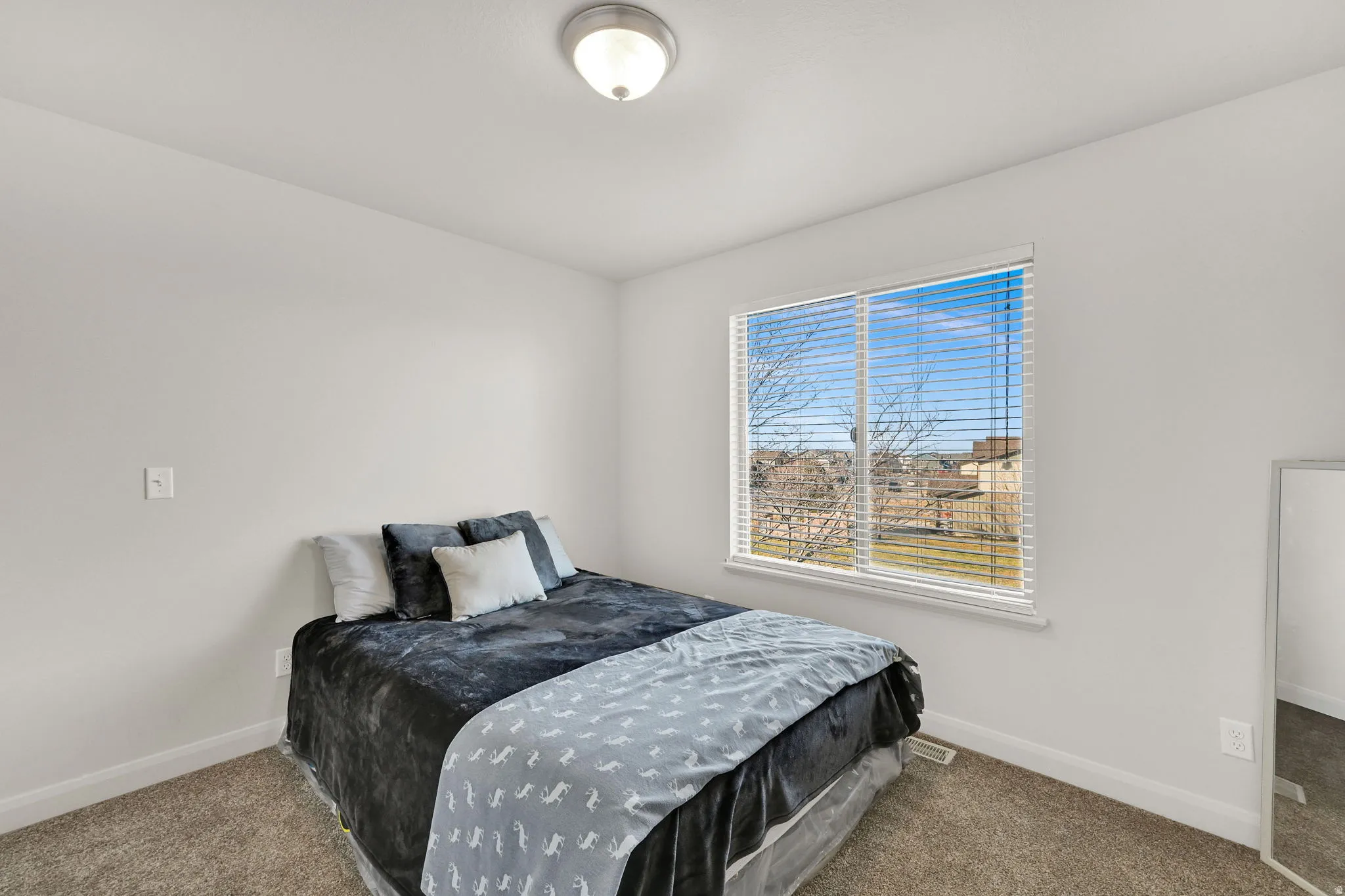 Carpeted bedroom featuring baseboards