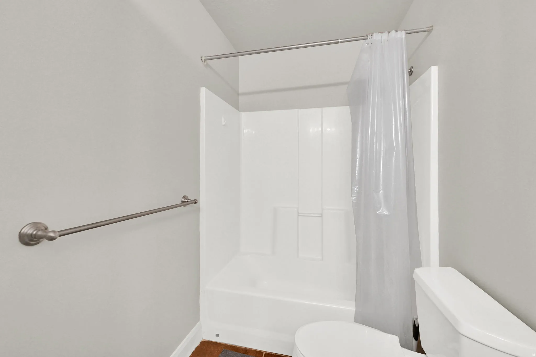 Bathroom with toilet and shower / bath combo with shower curtain
