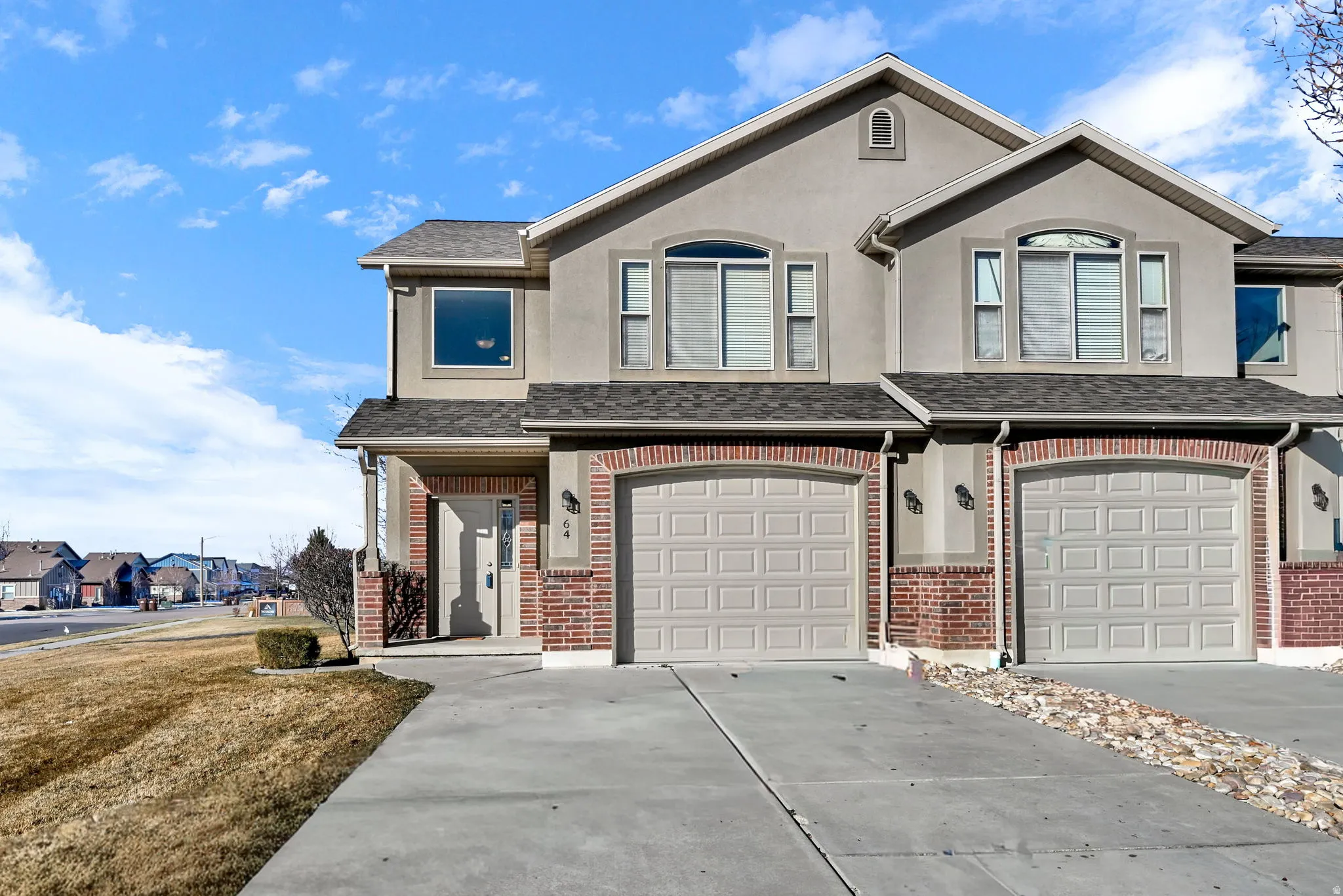 View of front of property featuring concrete driveway, a garage, and a shingled roof