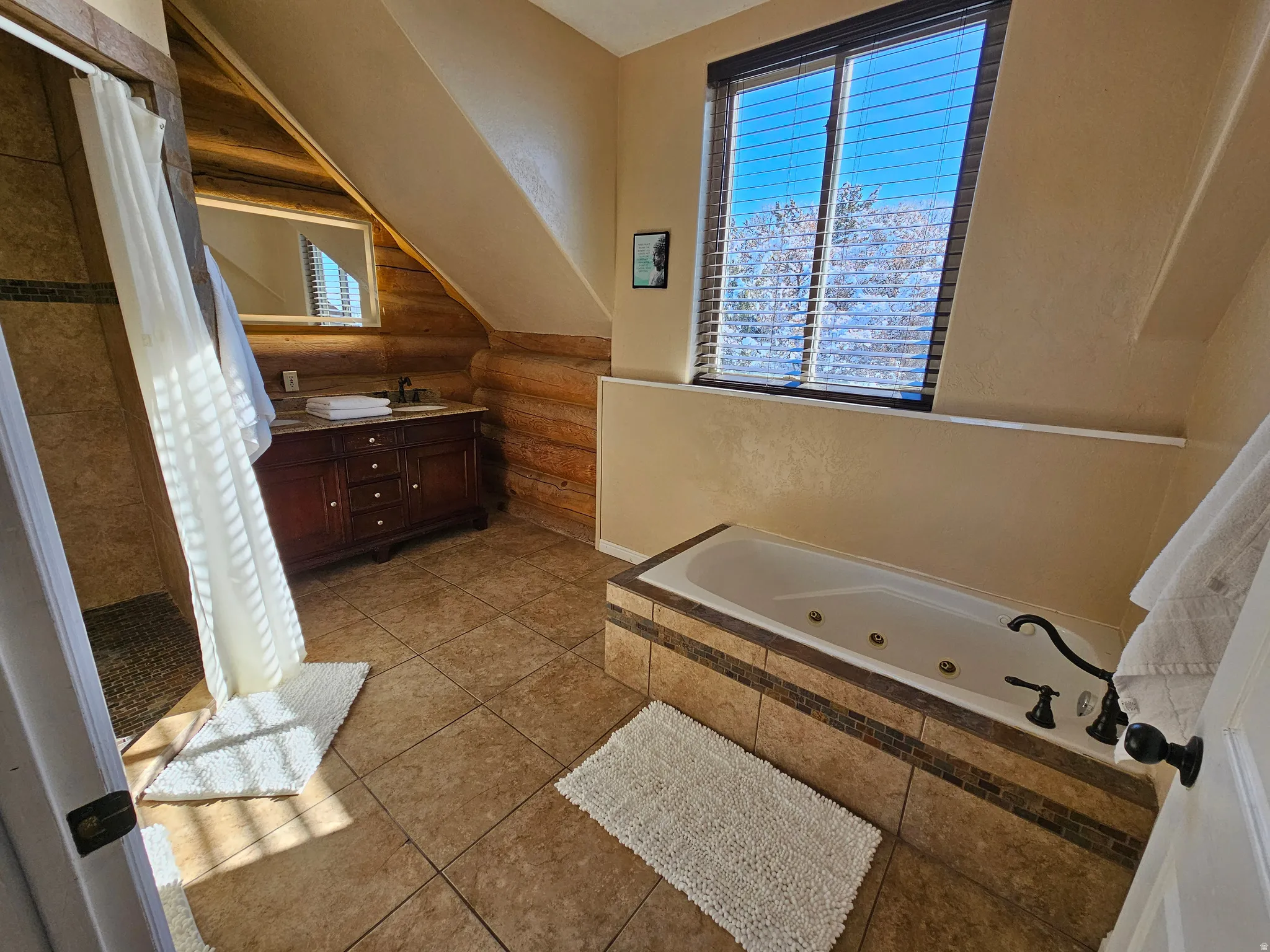Full bath featuring log walls, vanity, a whirlpool tub, a shower stall, and light tile patterned floors