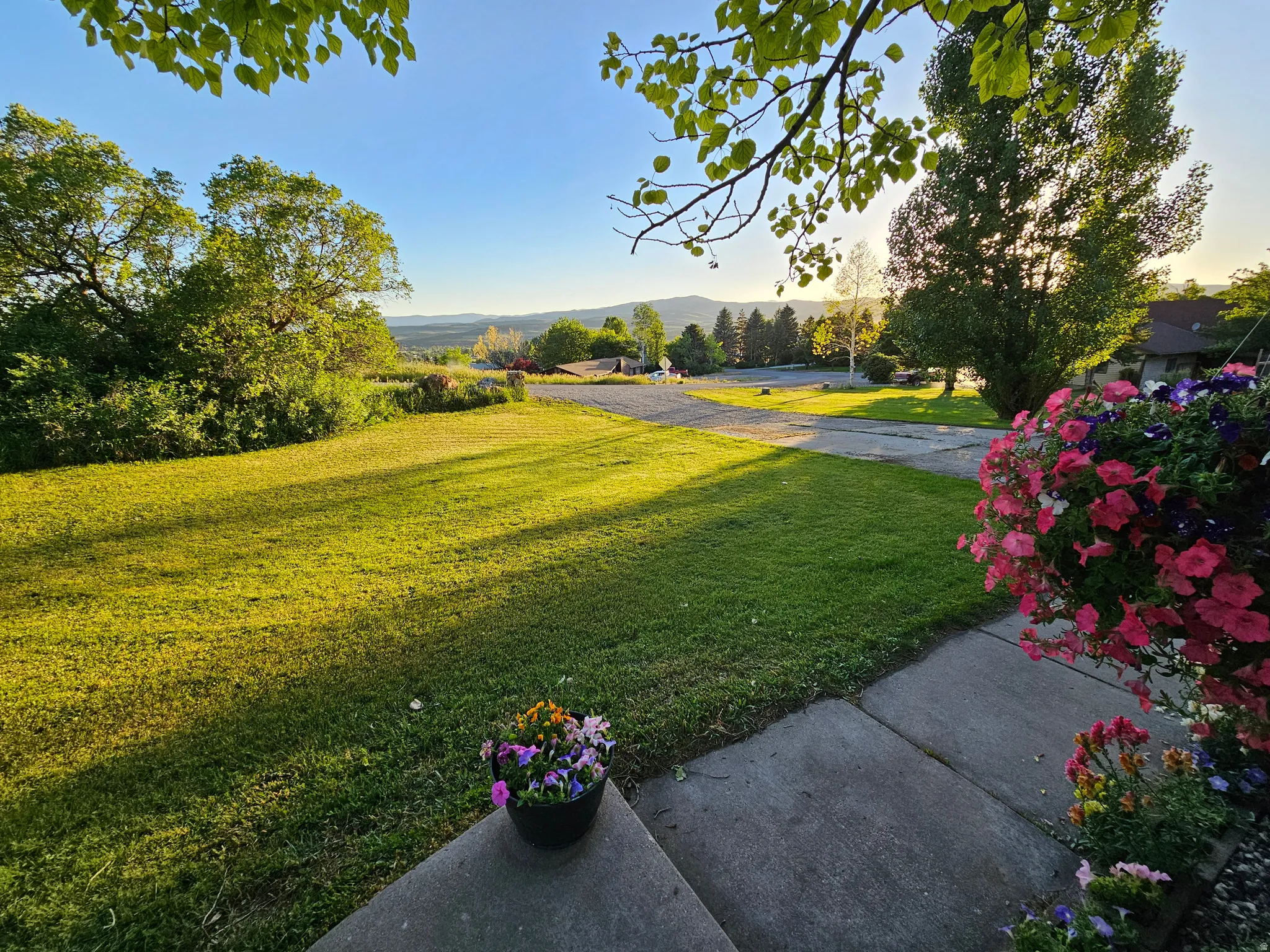 View of green lawn featuring a mountain view