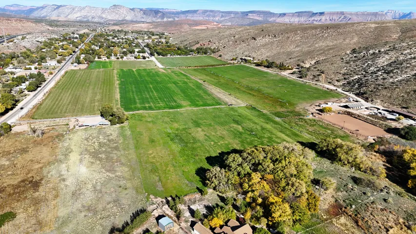 Aerial view of sparsely populated area with farmland and mountains