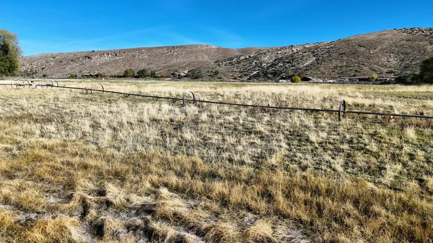 View of mountain backdrop with rural landscape
