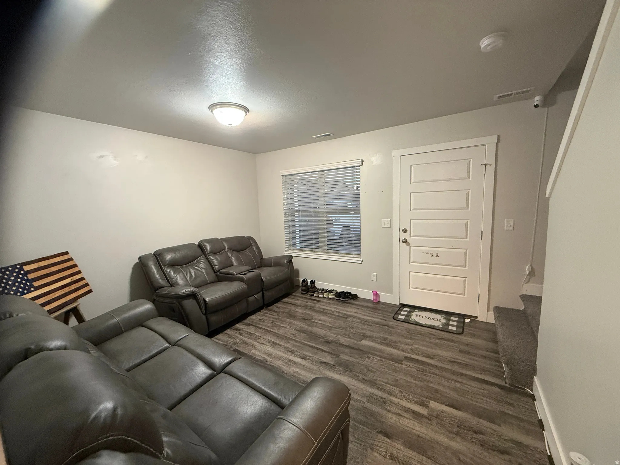 Living room with dark wood finished floors and baseboards