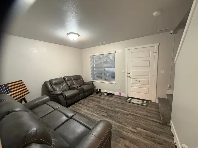 Living room with dark wood finished floors and baseboards