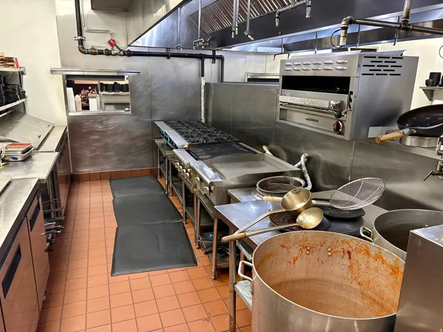Kitchen with stainless steel counters and open shelves