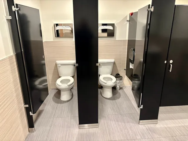Bathroom with a wainscoted wall and tile walls