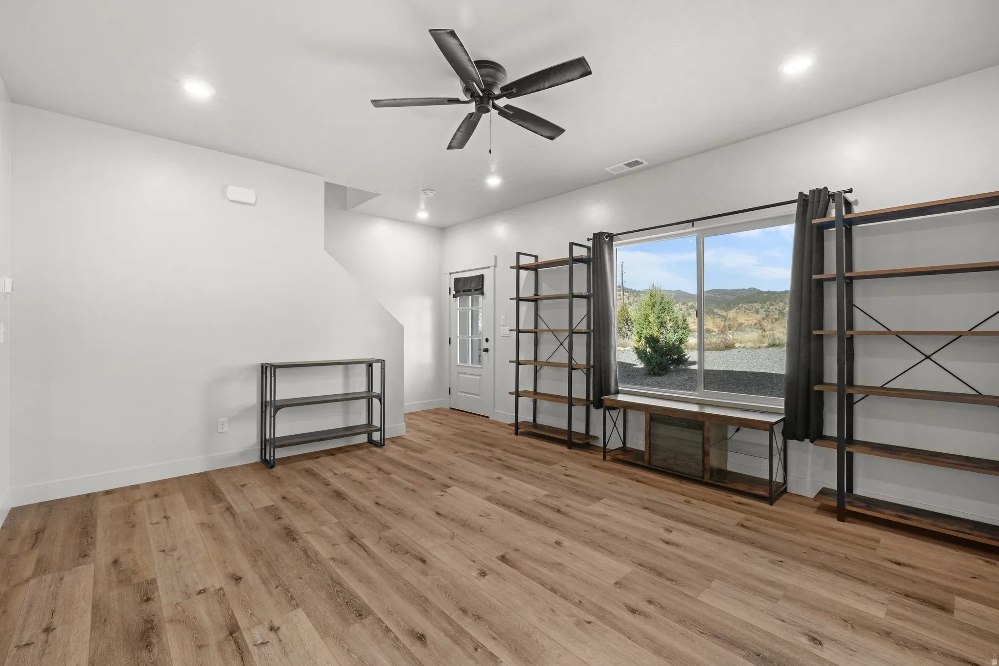 Unfurnished room with light wood-style flooring, ceiling fan, and recessed lighting