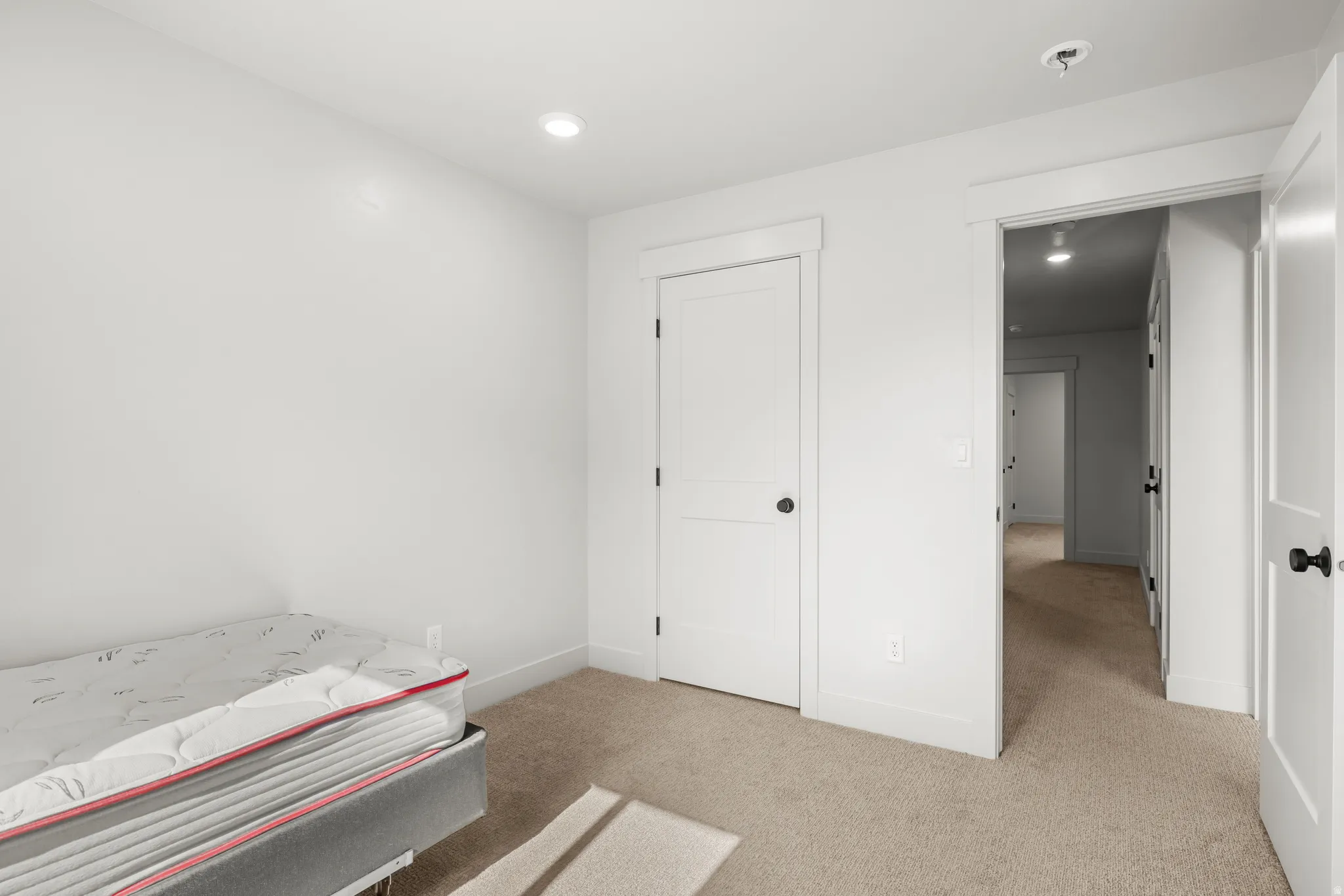 Bedroom 2 featuring light colored carpet and recessed lighting