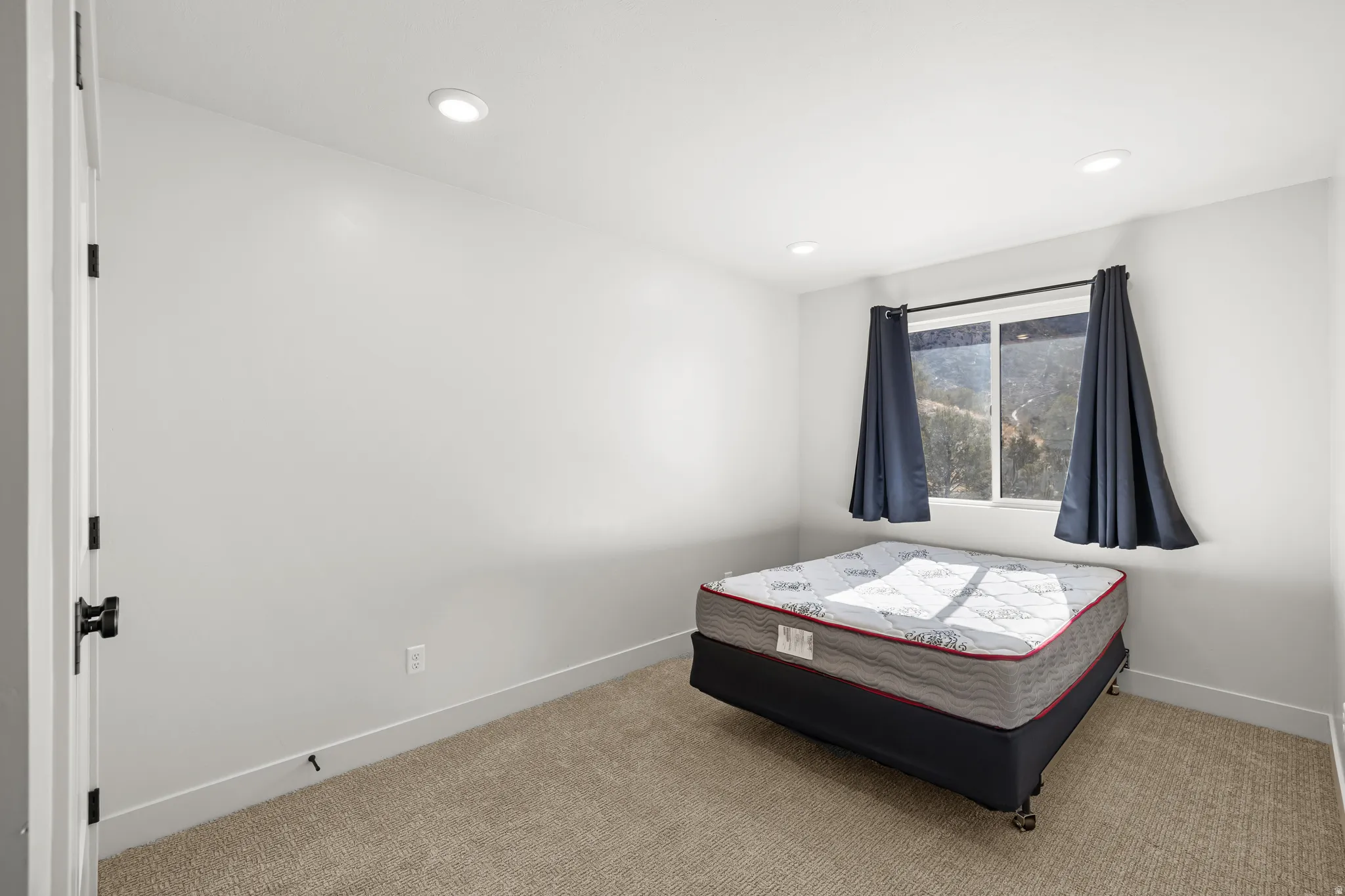 Bedroom 1 featuring carpet flooring and recessed lighting