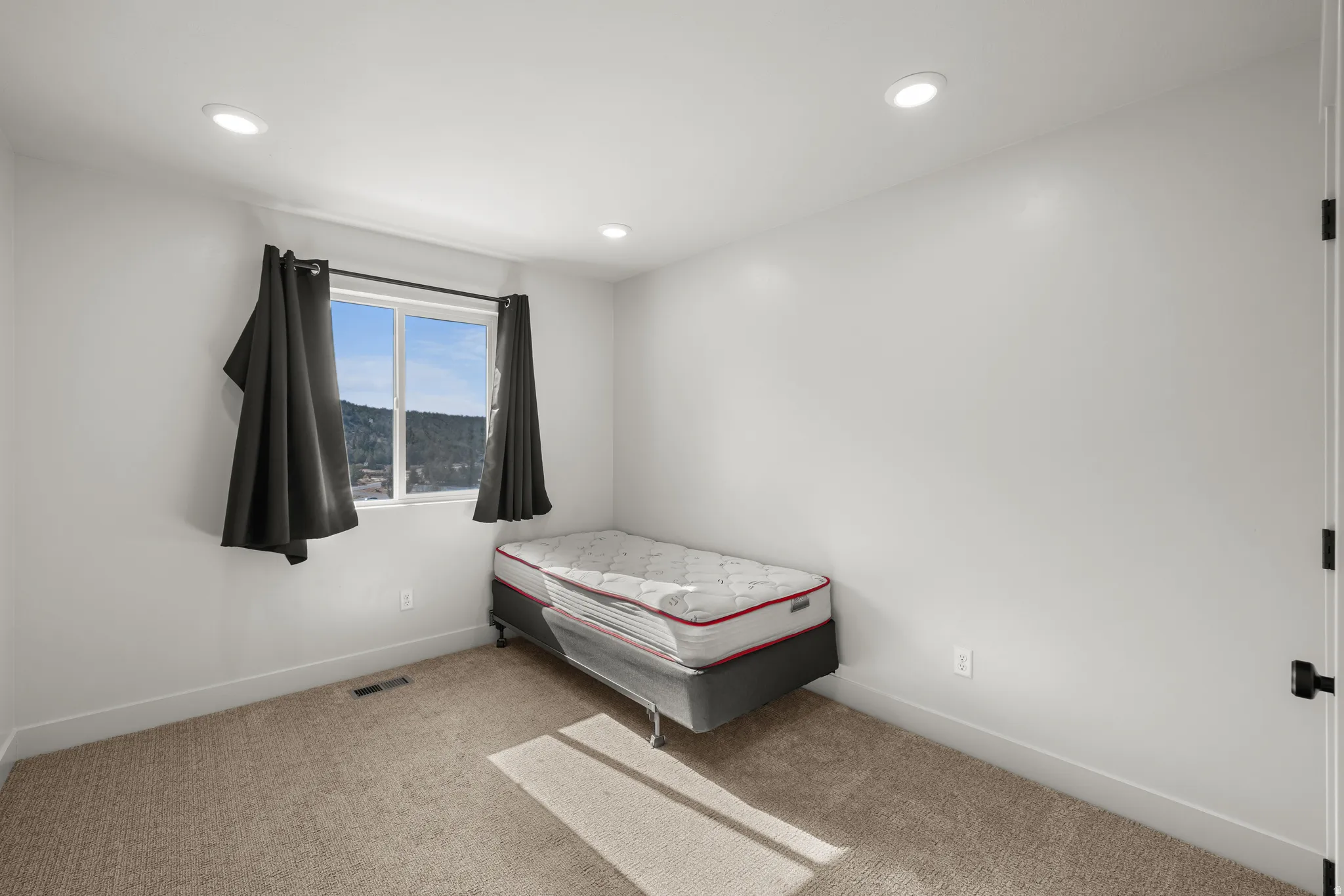 Bedroom 2 with carpet flooring and recessed lighting