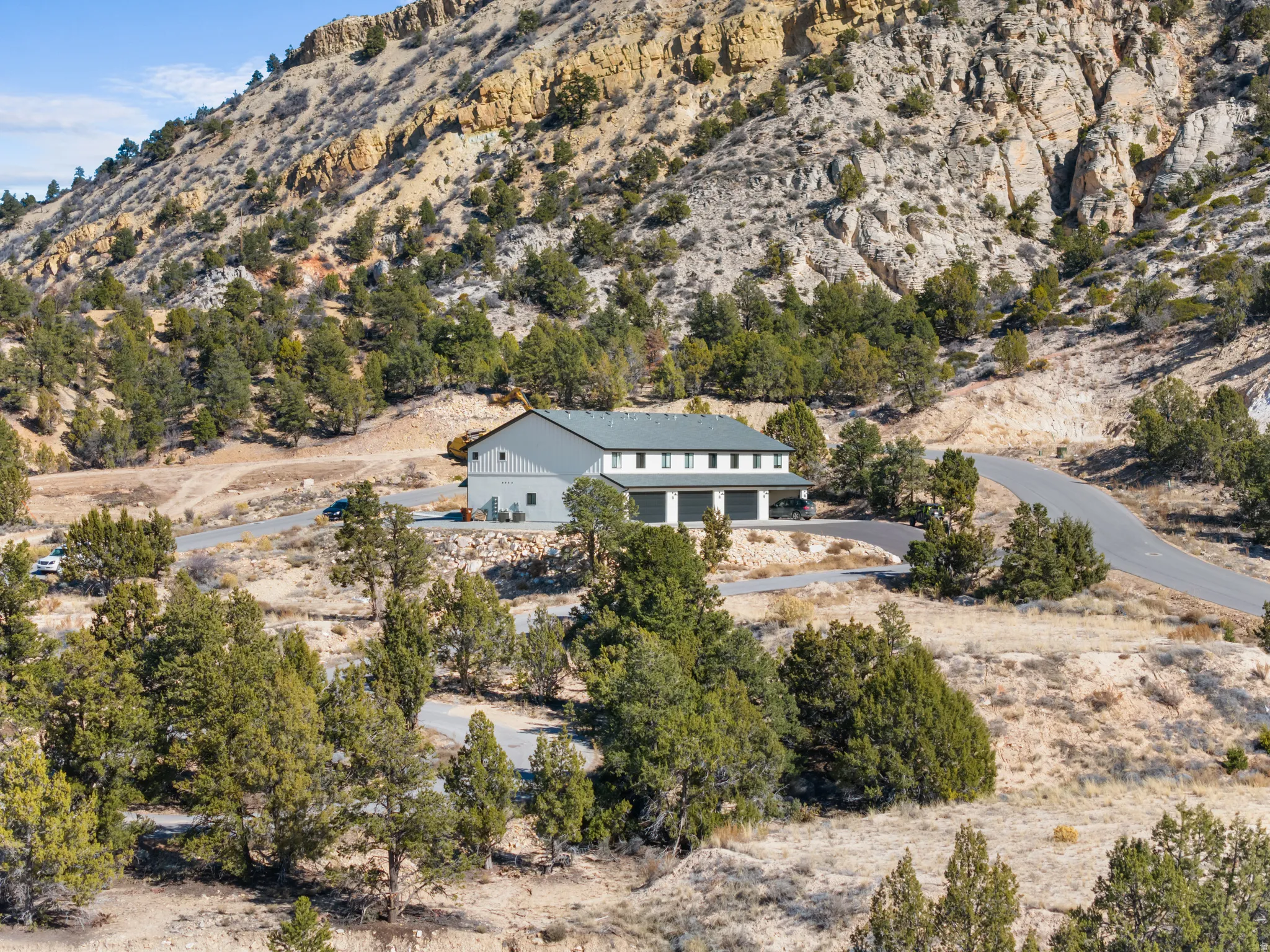 Aerial view of property and surrounding area with a mountainous background