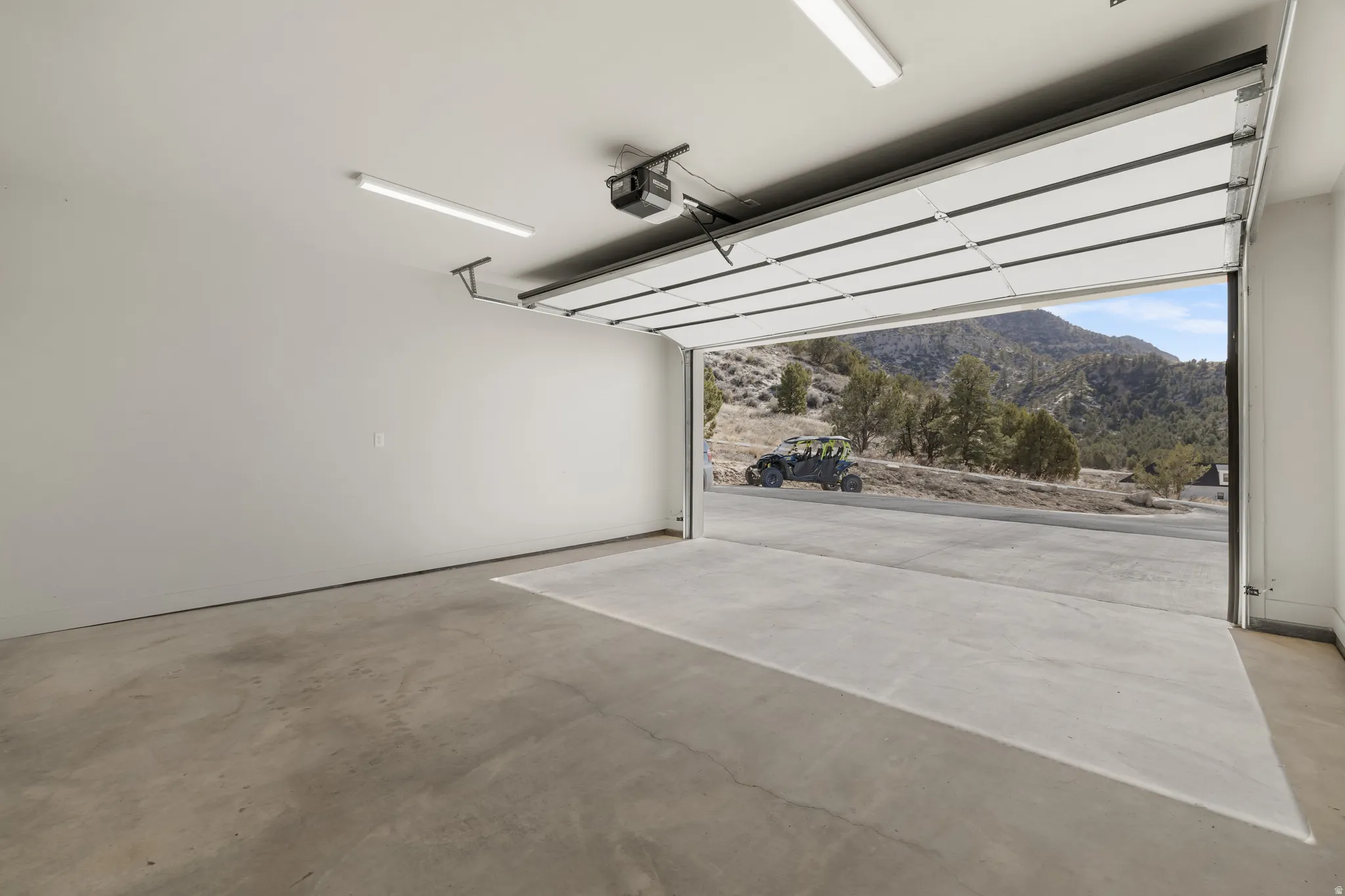 Garage with a mountain view and a garage door opener