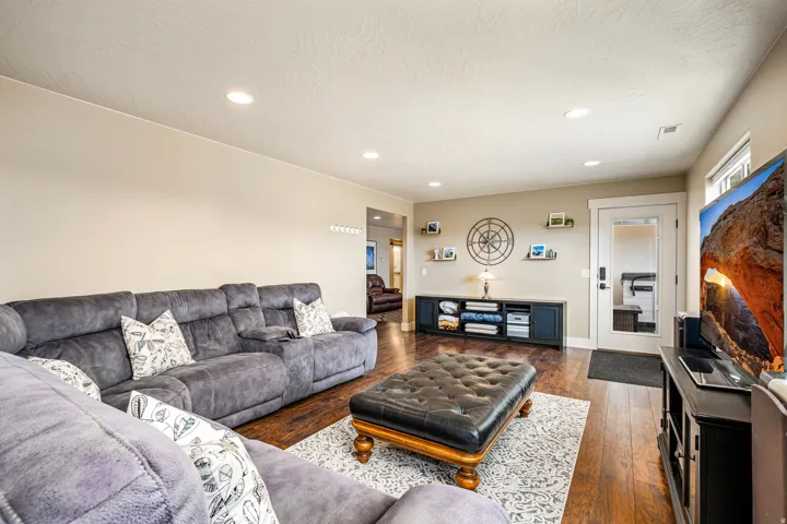 Living area featuring dark wood finished floors and recessed lighting