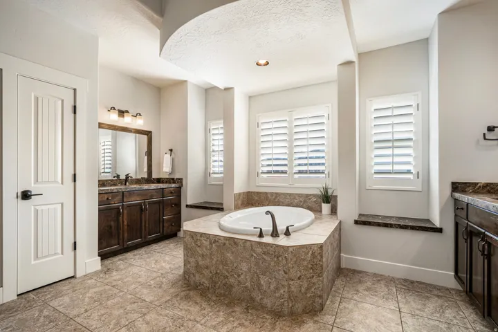 Bathroom with vanity, a garden tub, and recessed lighting