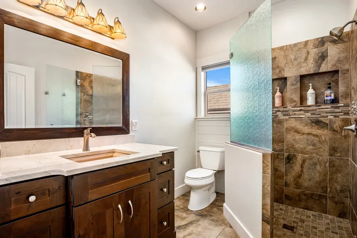 Full bathroom featuring a walk in shower and vanity