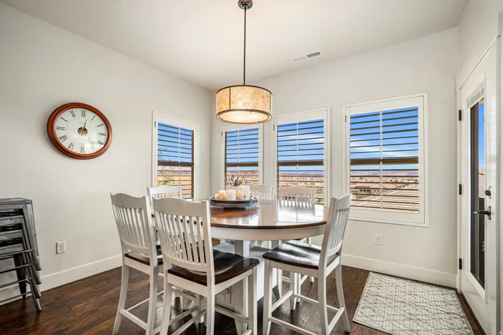 Dining area featuring healthy amount of natural light and dark wood-style floors