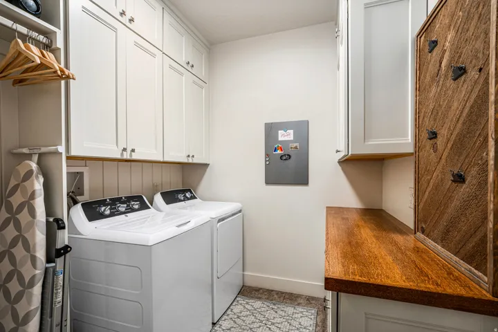 Laundry area featuring cabinet space and washing machine and dryer