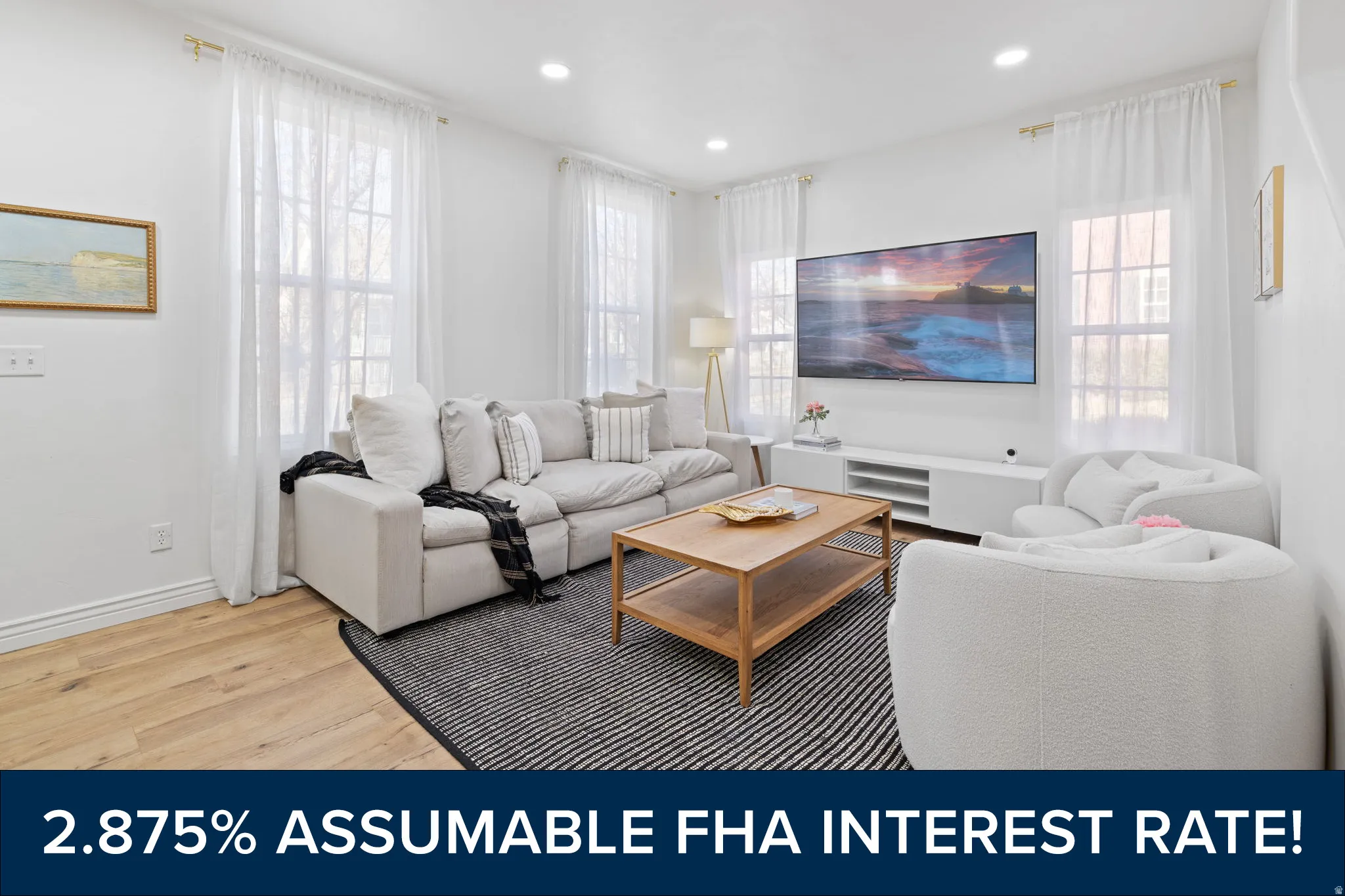 Bright living area featuring wood-finish flooring, recessed lighting, and multiple windows