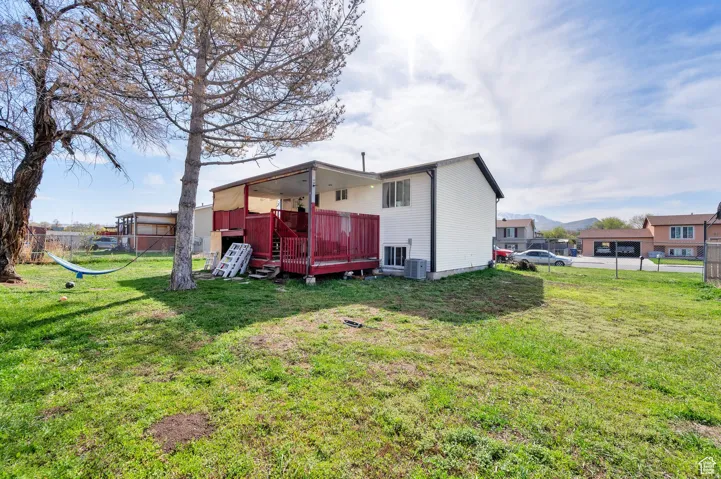 Back of house featuring a wooden deck