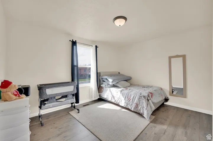 Bedroom with baseboards and light wood-style flooring
