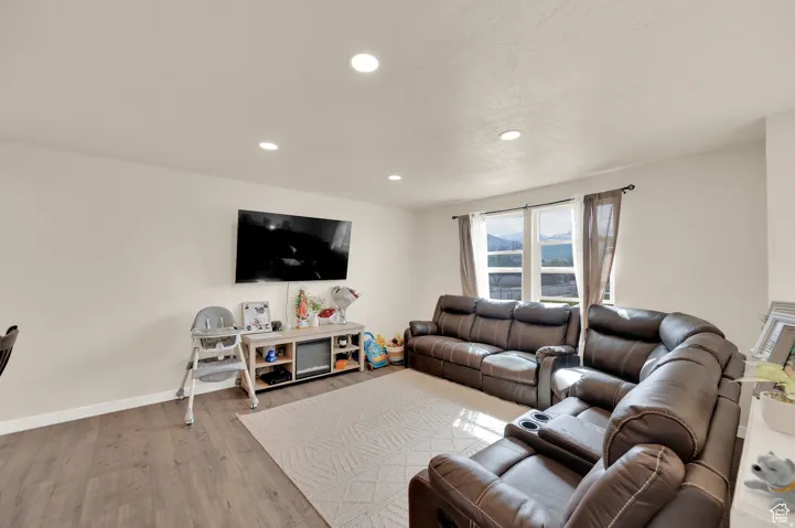 Living room featuring wood finished floors and recessed lighting