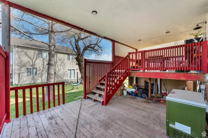 Wooden terrace featuring a yard and a playground