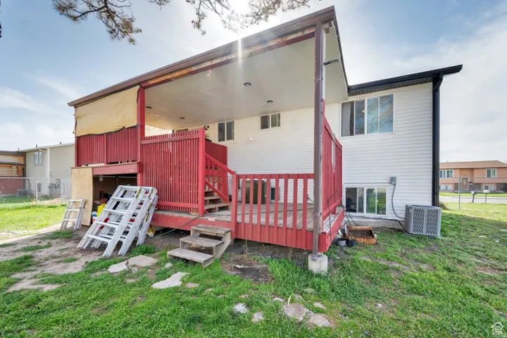 Rear view of house with a deck and stairs