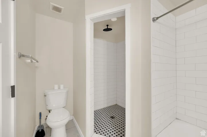 Full bath with a stall shower and toilet