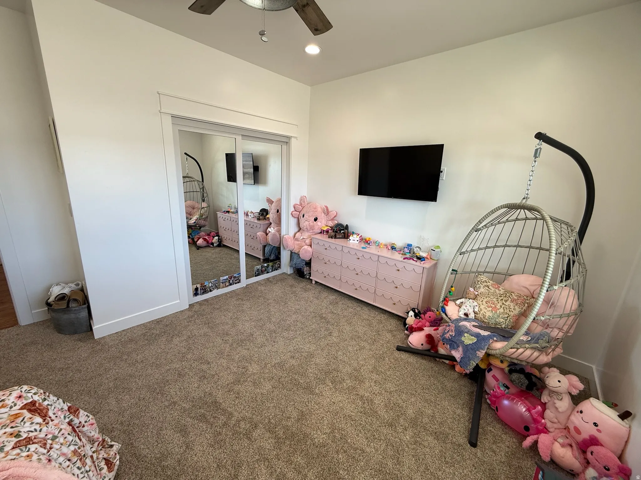 Spacious room featuring neutral carpet flooring and white walls