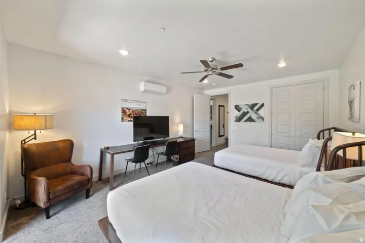 Bedroom with carpet floors, a desk, a closet, a ceiling fan, and recessed lighting