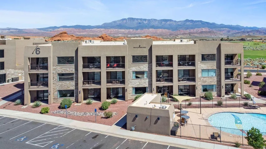 View of apartment building / complex with a mountain view and a community pool