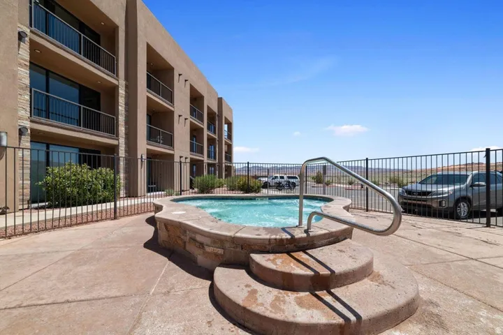 View of pool with a swimming pool, a community hot tub, and patio surround