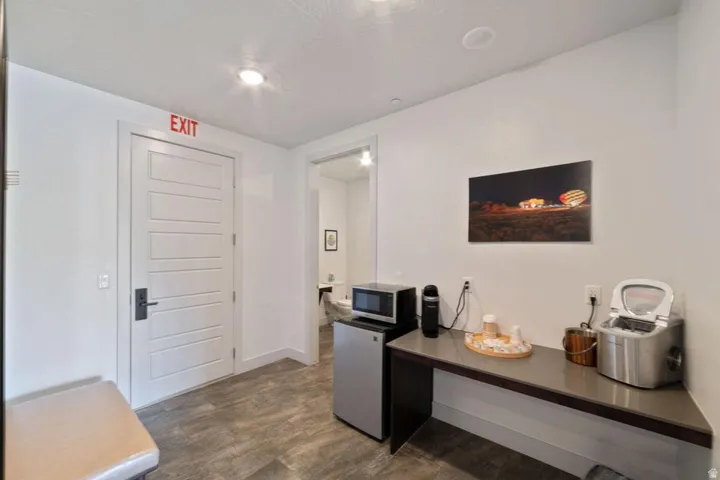 Office space with dark wood-style floors and baseboards