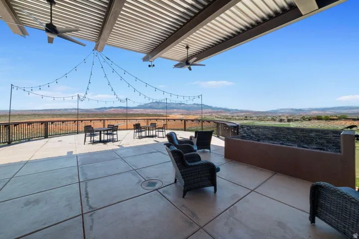 View of patio / terrace with a mountain view, ceiling fan, and outdoor dining area