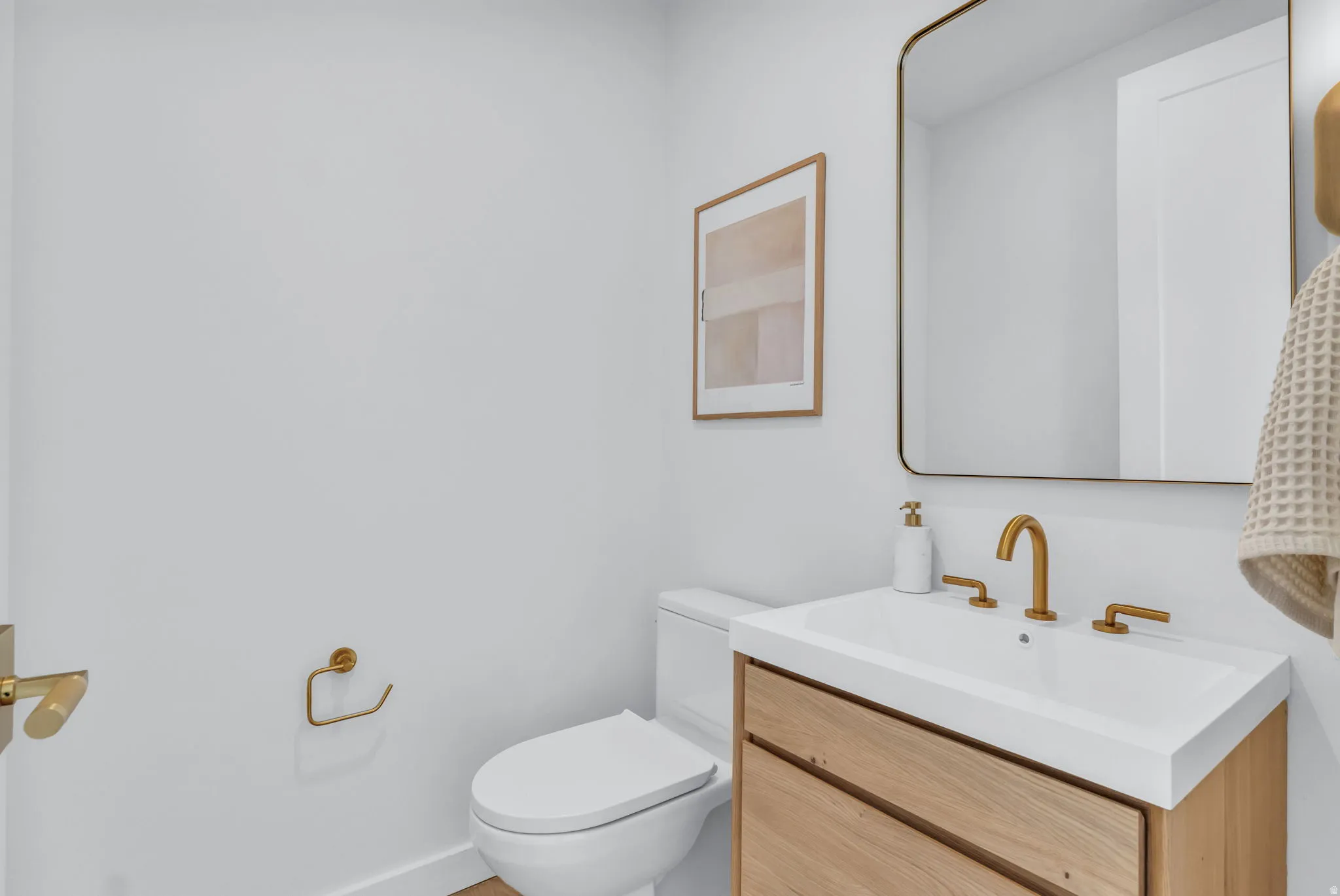 Half bath featuring vanity and toilet