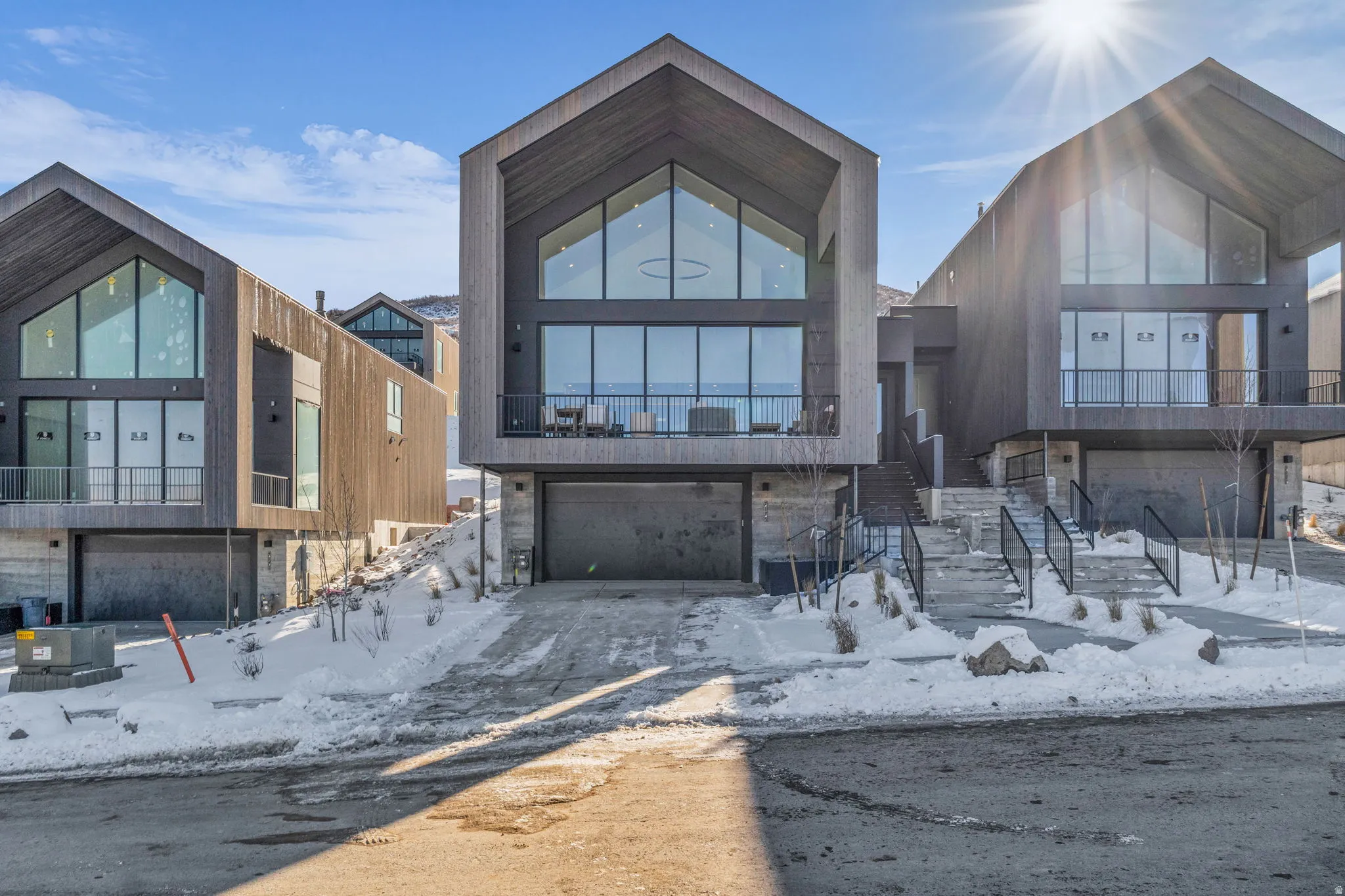 Contemporary home featuring an attached garage and a balcony