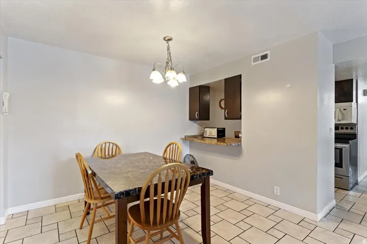 Dining area featuring suspended lighting and baseboards