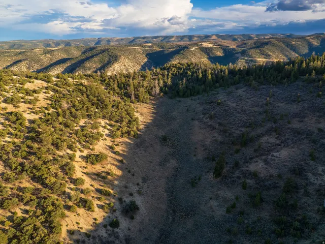 Aerial view of property and surrounding area with mountains