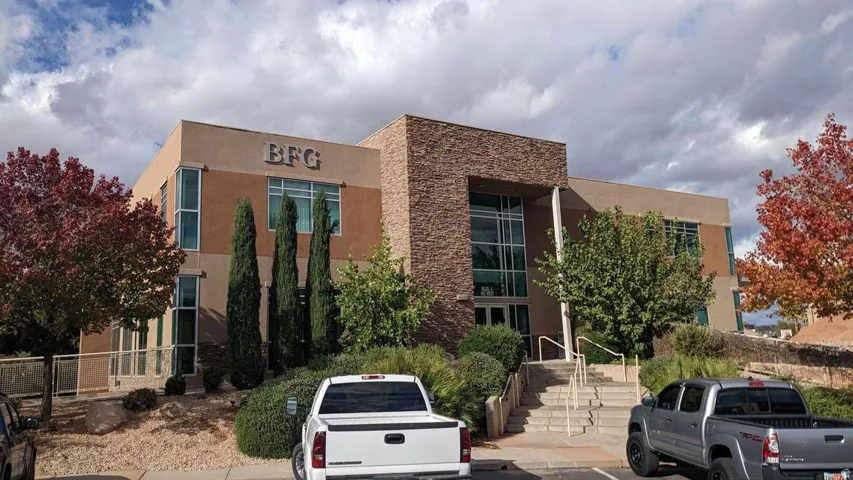 View of property with uncovered parking